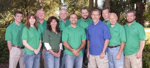 Group of professionals in green shirts outdoors